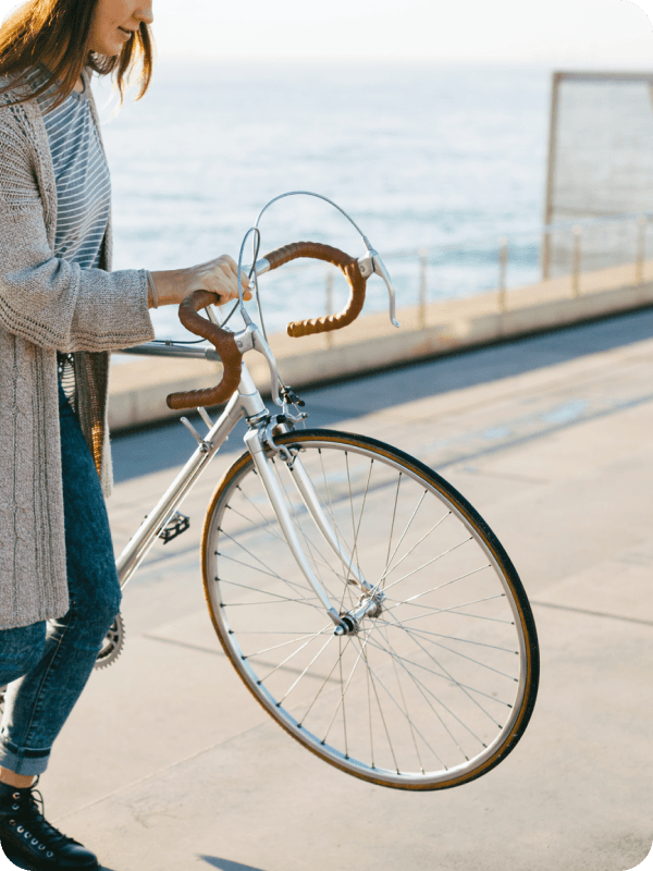 Woman holding her insured bicycle.