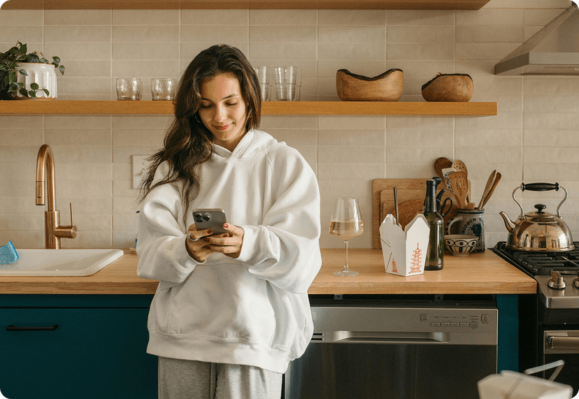 Woman looking at her phone at her place