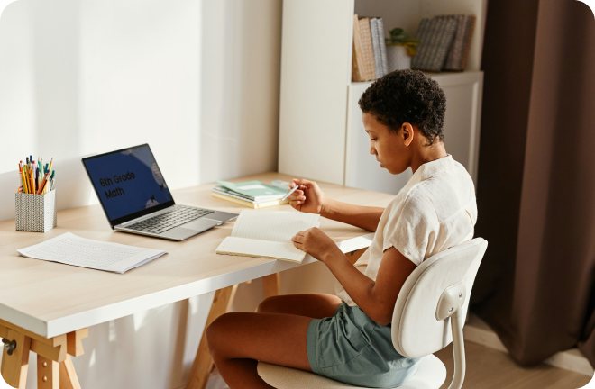 Photo of a boy siting at his desk, studying.
