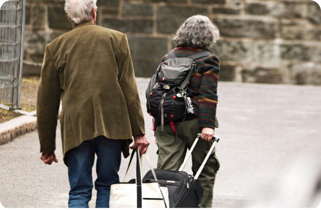 An elderly couple walking with their backs to the camera