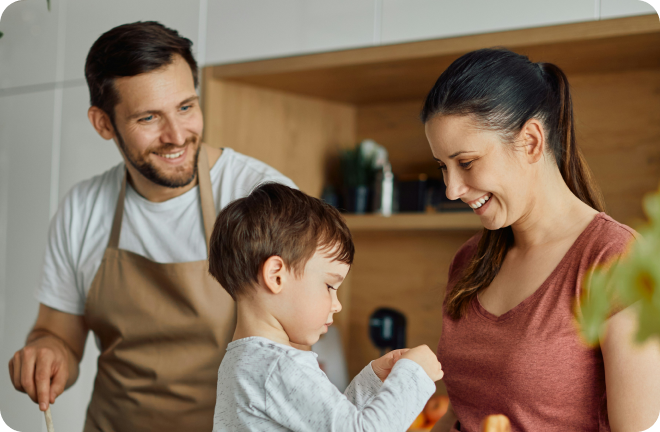 Photo of a family in the kitchen smiling