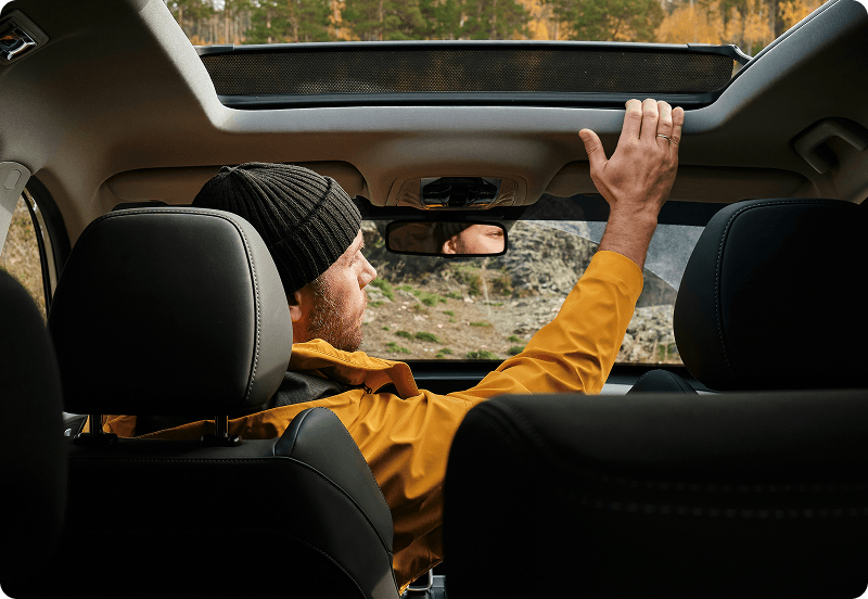 A man sitting in his parked car.
