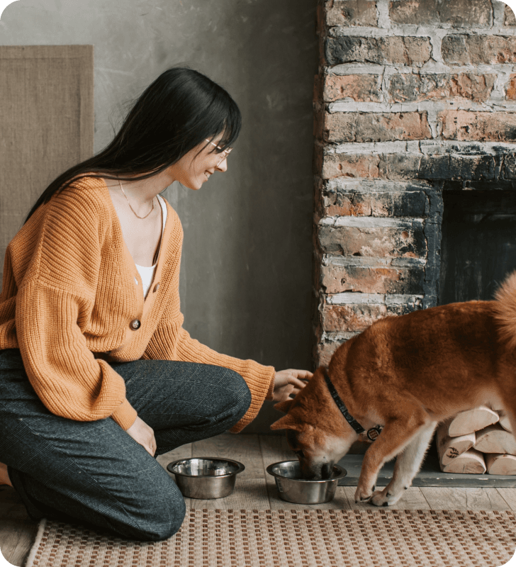 Woman feeding her dog.