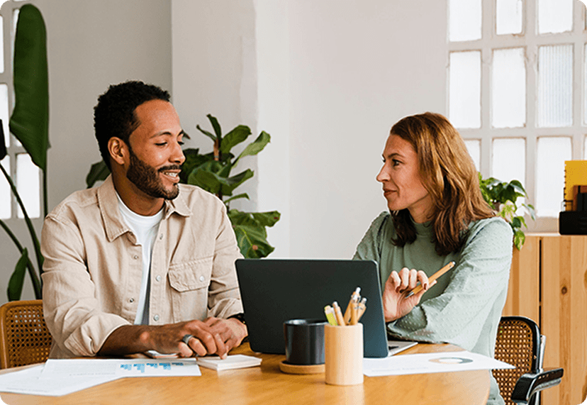 Two people looking at a computer.