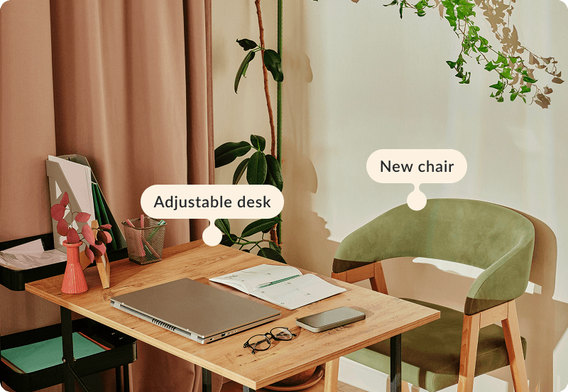 A corner of a room with a desk, a chair and a laptop. The tags ready "New chair" and "Adjustable desk".