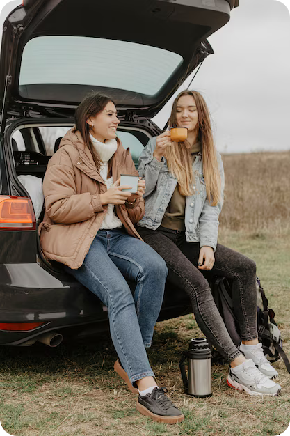Woman sitting in trunck of a car