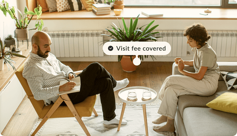 2 people sitting around a table with a visit fee covered label