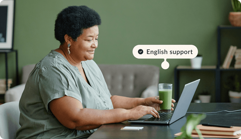 women sitting looking to a laptop