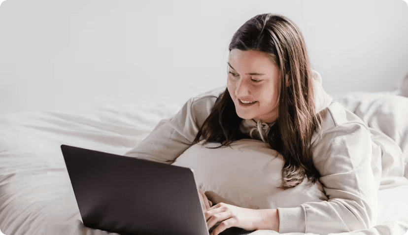 A smiling woman working on laptop