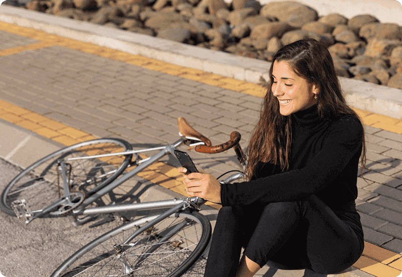 Woman sitting next to her road bike.