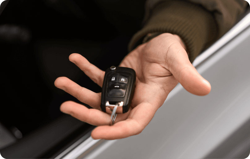 Person holding the keys to a car