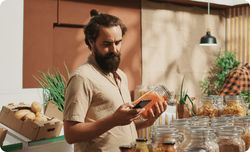 Man looking at his phone while shopping at a market in Italy.