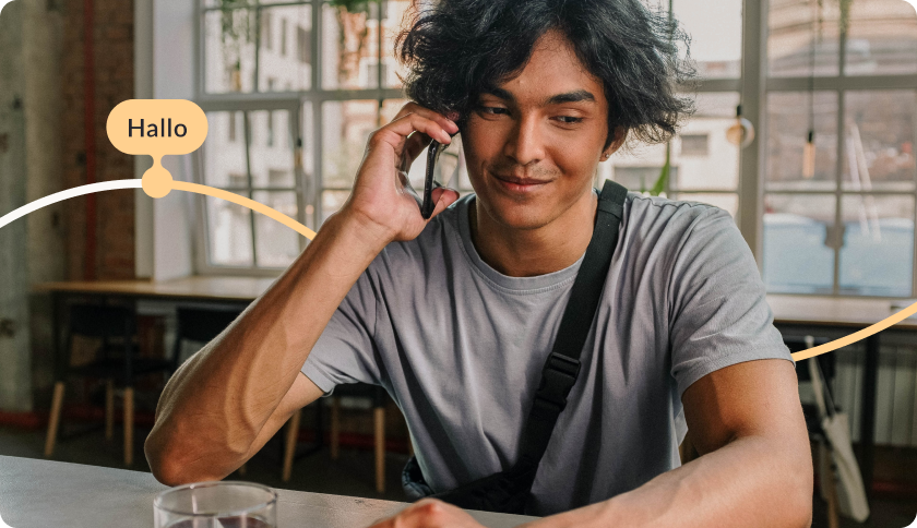 Man talking on a phone and smiling. The tag says "Hello"
