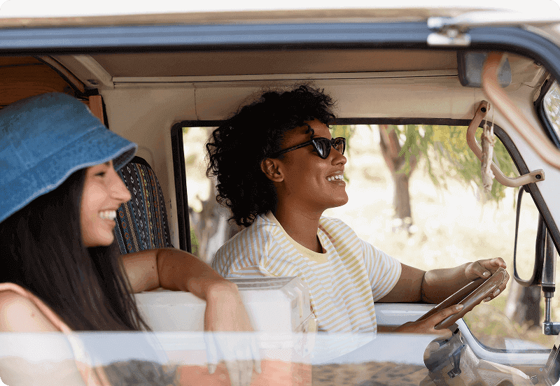 Two people going on a road trip in their car.