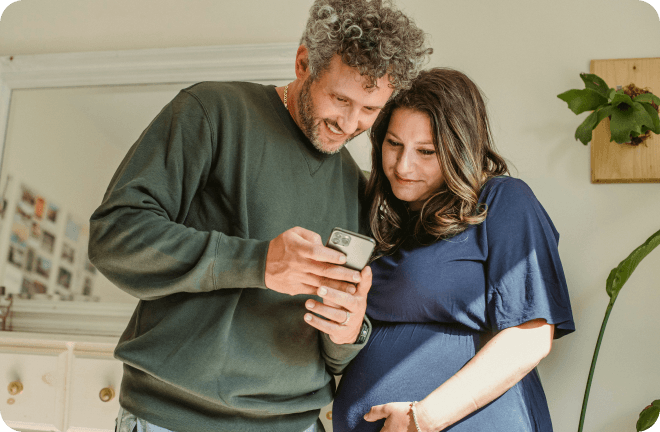 a young couple watching a phone