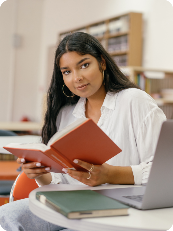 Woman reading a book while studying.