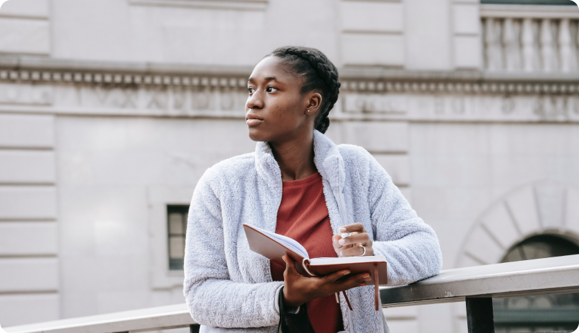 Woman standing with a book in hand