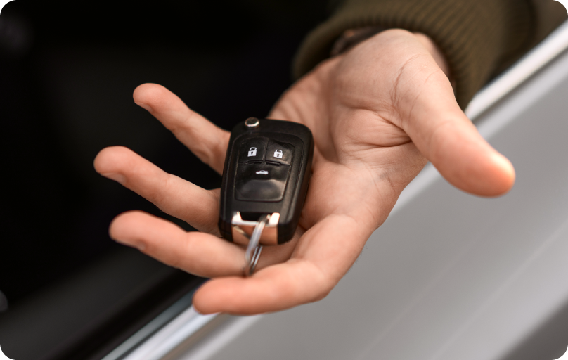 Person holding a car key.