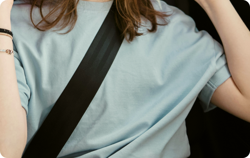 Girl in a car with a safety belt on.