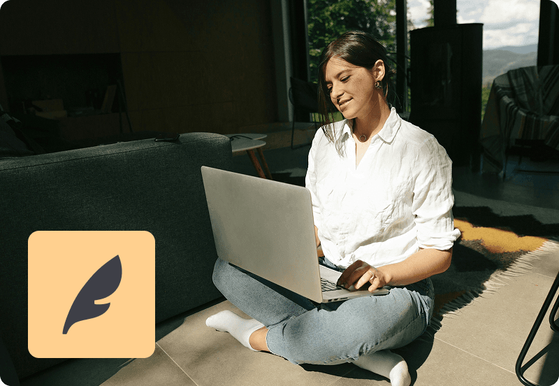 A girl looking at her laptop and smiling. Feather logo in the corner.