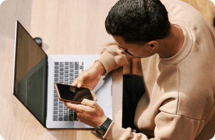 A man looking for expat health insurance on his phone in Sweden