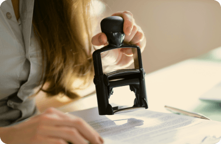 A public office representative approving documents with a stamp in Sweden.