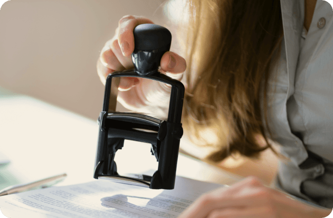 A public office representative approving documents with a stamp in Sweden.