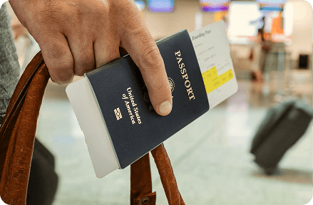 Person holding a passport in their hand at the airport.
