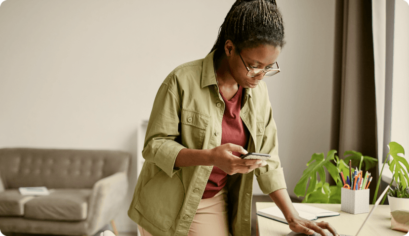 A middle-aged woman checking insurance details on her phone.