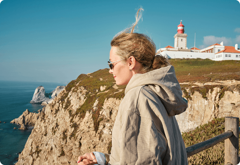 A woman visiting the Portuguese seaside.