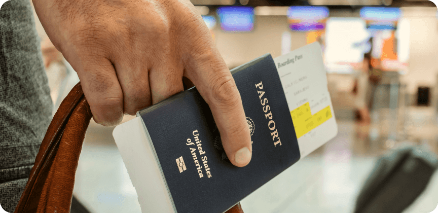 Person holding a passport in their hand at the airport.