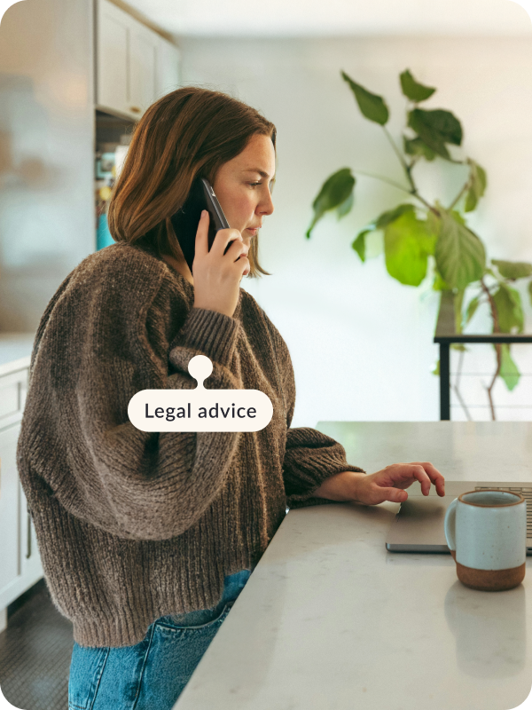 Person standing at their house and talking on a phone. The tag next to the phone reads "Legal advice".