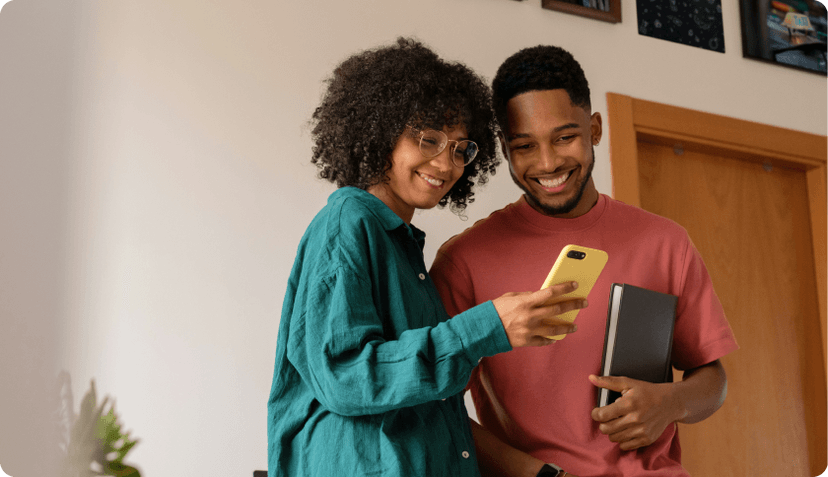 A couple living in Portugal checking their health insurance on their phone.