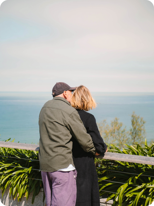 Older couple on vacation looking at a see view.