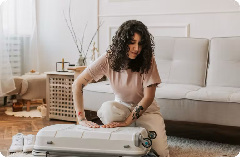 Person packing a suitcase.