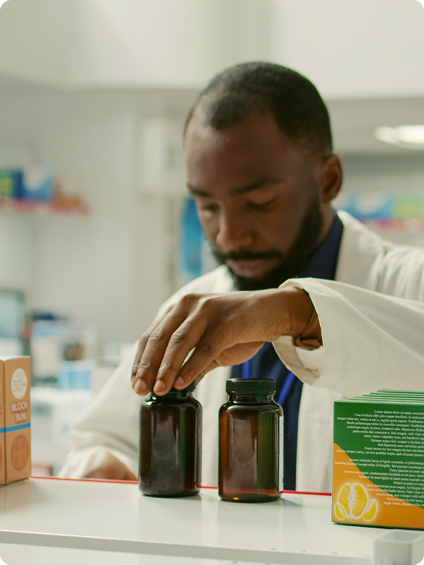 Pharmacists organizing medicine on a shelf.