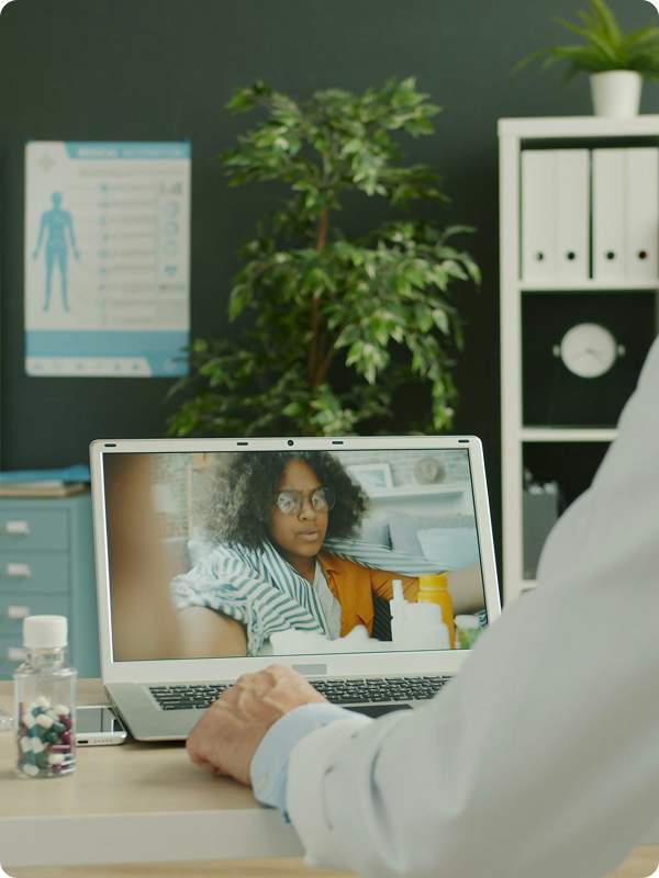 A sick person having a telemedicine video call with her doctor.
