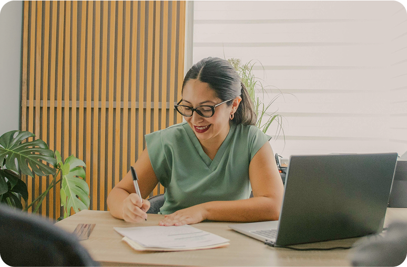 Doctor in scrubs filling in medical papers.