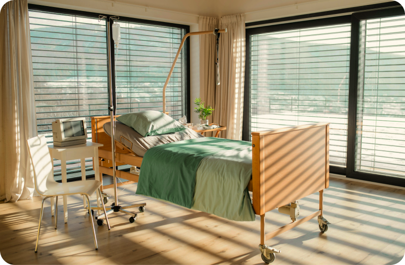 A private hospital room with a bed and medical equipment.