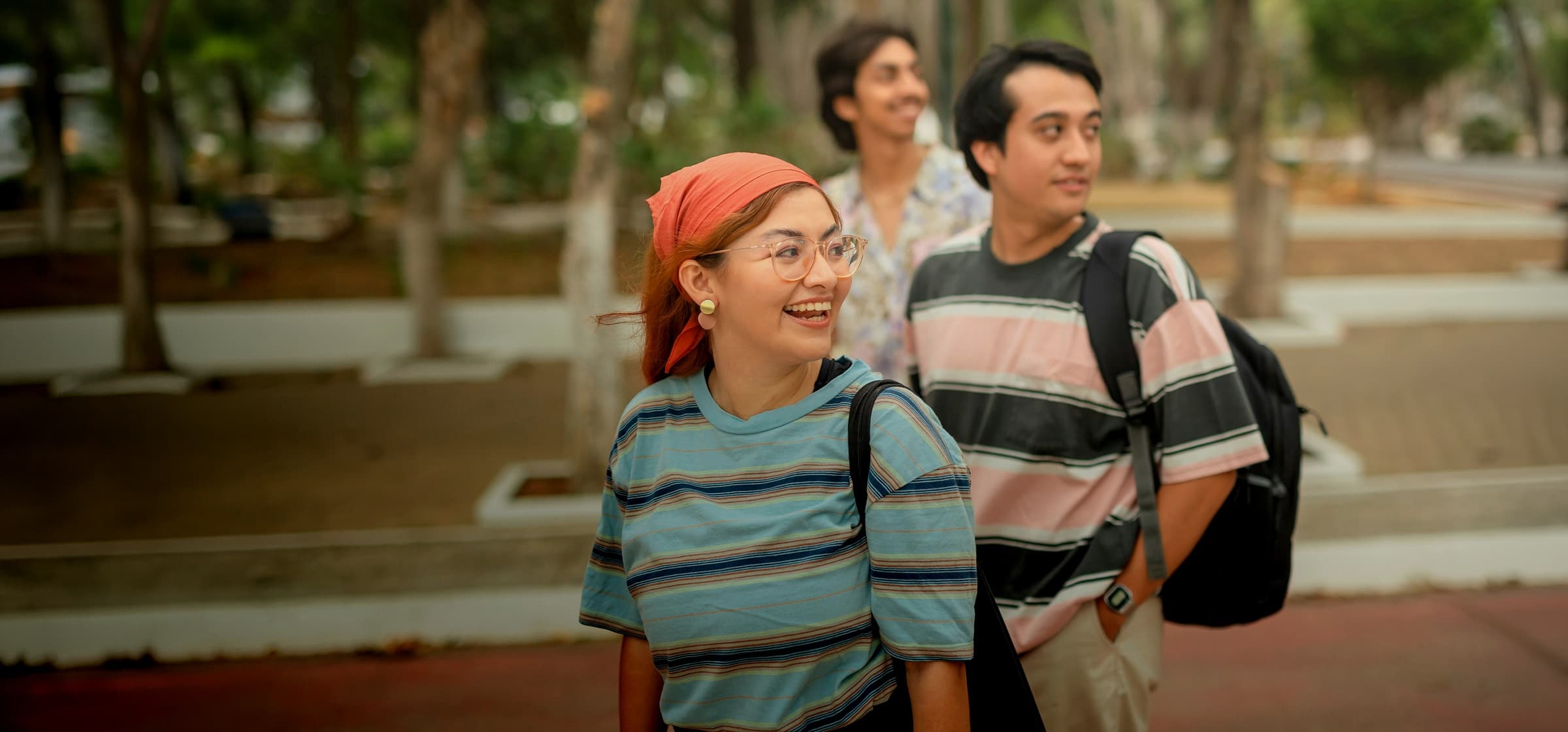 A group of three friends in a park