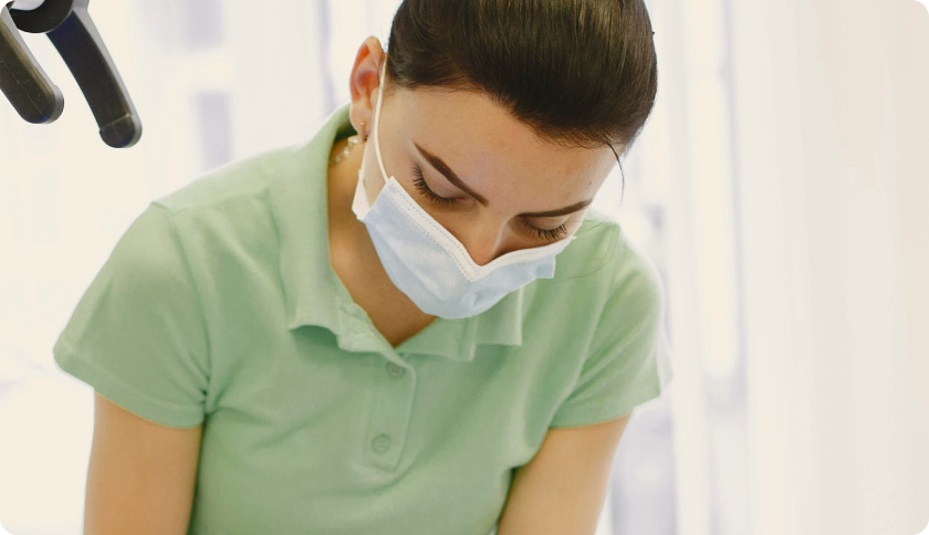 Dentist wearing a mask, working.